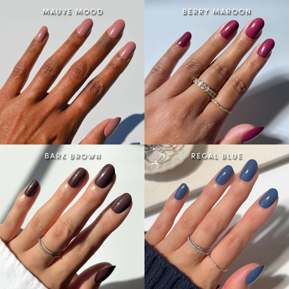 Four hands with manicured nails, each in a different shade—Mauve Mood, Berry Maroon, Bark Brown, and Regal Blue—display glamnetic’s Short Round Study Set. Each hand wears rings, highlighting these salon-quality press-on nail sets in stunning jewel tones. - Product image