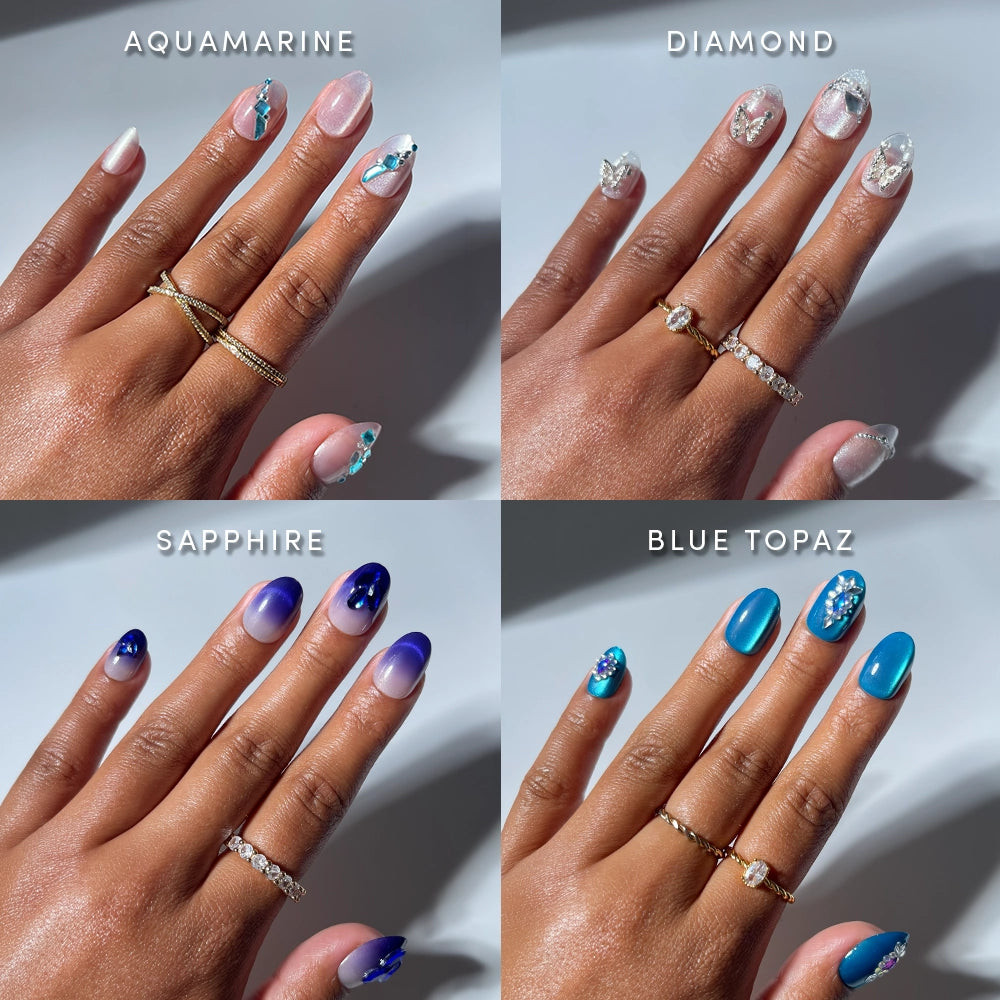 Four manicured hands showcase gemstone-inspired nail art from glamnetic’s Short Oval Attraction collection: top left aquamarine with soft blue accents, top right diamond with clear and silver details, bottom left sapphire with deep blue tones, and bottom right blue topaz featuring bright blue hues and 3D gemstones—all beautifully displayed on short oval press-on nails.