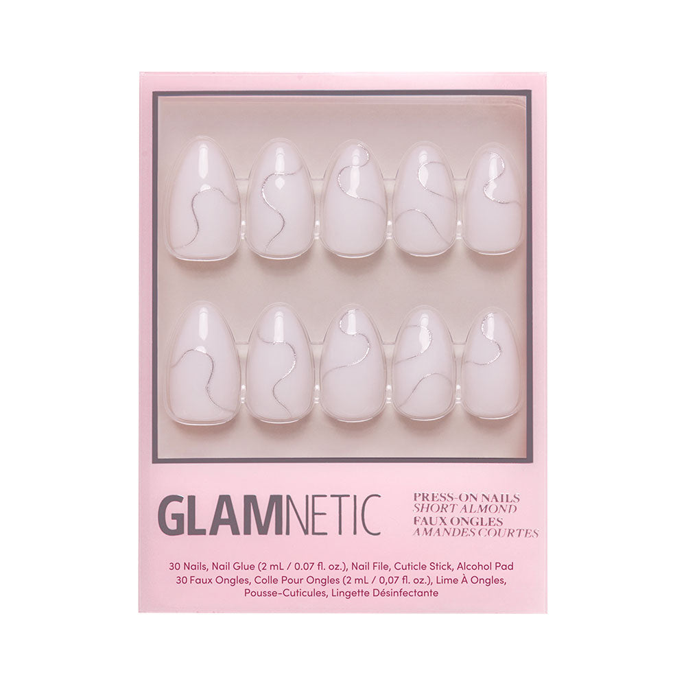 Silent Night by glamnetic is a winter-style press-on nail set with short almond shapes, a soft pink base, and subtle silver wavy lines, all showcased in clear window packaging. - Product image