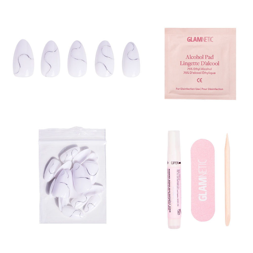 The glamnetic Silent Night winter nail set features short almond press-ons, extra nails, an alcohol pad, glue tube, pink file, and wooden cuticle stick—all displayed on a white background. - Product image