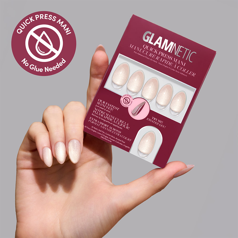 A hand holds a package of Glamnetic Snow Haze shimmering, extra short almond press-on nails. - Product image