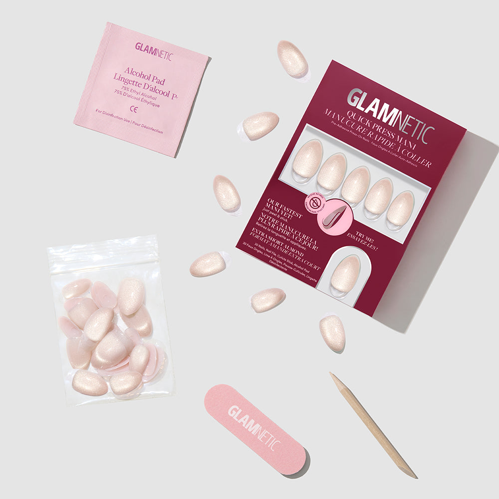 A box of Snow Haze extra-short almond-shaped press-on nails with a shimmery finish, including an alcohol pad, nail file, and wooden cuticle pusher for a quick press mani. - Product image