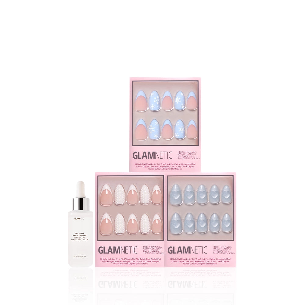 Three boxes of glamnetic Snow Play press-on nails with pink and blue glitter French tips are stacked next to a white Glamnetic Press-On Nail Remover bottle, all set against a white background. - Product image