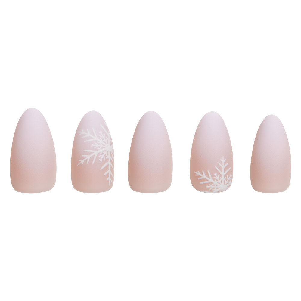 Five short almond nails from glamnetics Snowdrift set display a matte nude gradient with snowflake accents on the second and fourth nails, all arranged in a row against a white background. - Product image