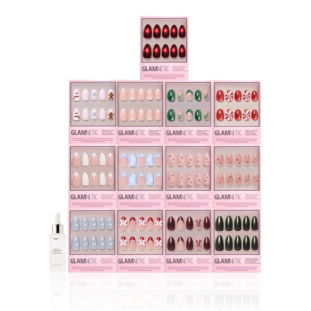 The glamnetic Snowed In Collection almond press-on nails in festive holiday designs are arranged in a pyramid, with a dropper bottle of nail glue on the left, all set against a white background. - Product image