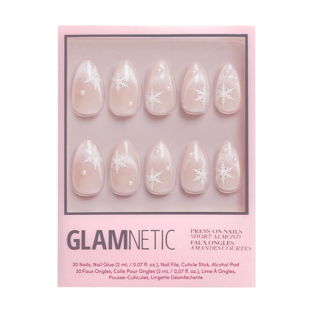 The glamnetic Snowfall set features short almond nails in light pink with snowflakes and pearls. Each box includes 30 nails plus essential nail care accessories. - Product image