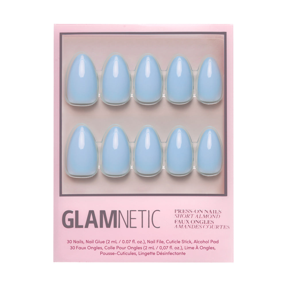 The Soft Blue Nail Set by glamnetic showcases ten short almond-shaped, glossy press-on nails in pink glamnetic packaging. Accessories and instructions are listed at the bottom of the box. - Product image