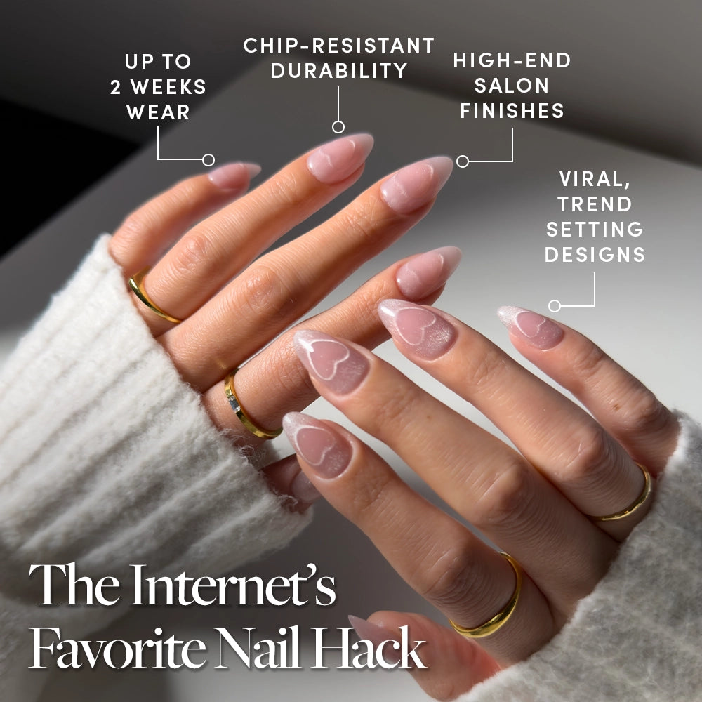 Close-up of hands with long, nude-pink velvet "Soulmate Energy" nails by glamnetic, showcasing a chic cat-eye heart design. Enjoy chip-resistant durability, a high-end finish, trend-setting style, and up to 2 weeks of flawless wear. - Product image