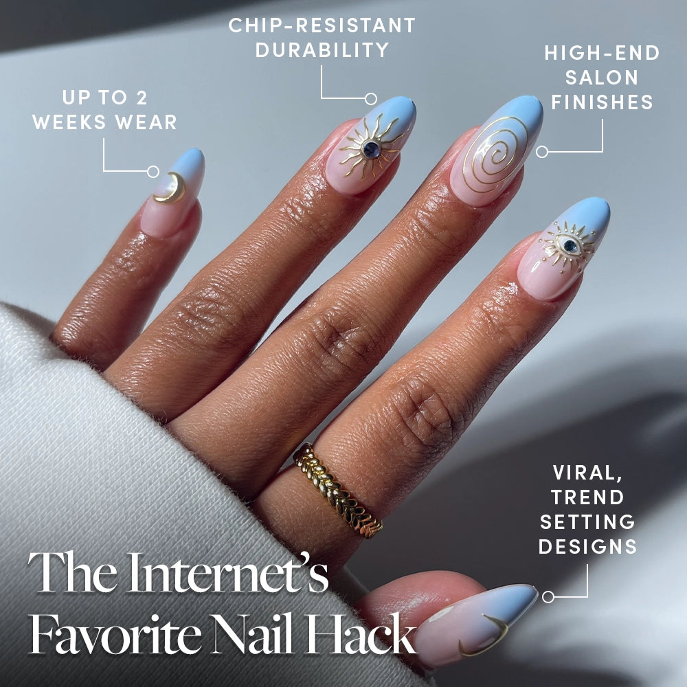 A hand with long, almond-shaped glamnetic Spirited Sky press-on nails in blue and pink with gold and white celestial designs. Text highlights chip-resistant durability, high-end finish, up to 2 weeks' wear, and viral nail inspiration. - Product image