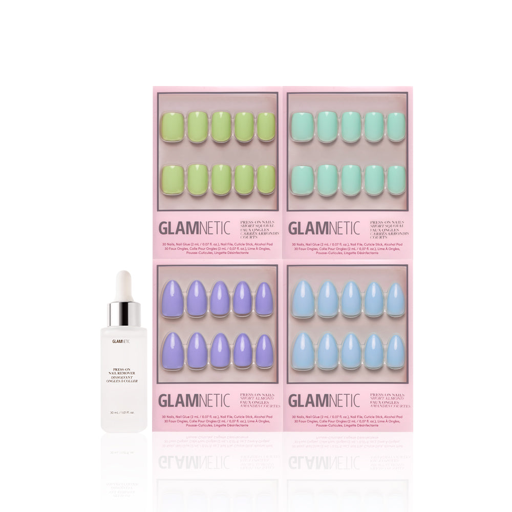 Four boxes of glamnetics Spring Day press-on nails in green, mint, purple, and blue are arranged in a grid, with a bottle of glamnetic cuticle oil displayed in front on a white background. - Product image