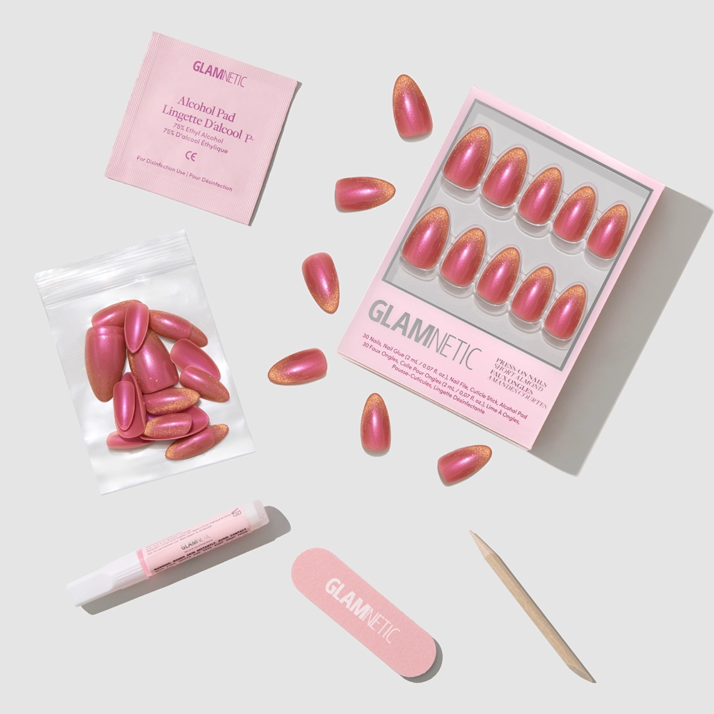 Glamnetic Starbeam set features short almond pink nails with a velvet finish, nail glue, alcohol pad, file, cuticle stick, and extra nails—all cruelty-free and beautifully arranged on a light gray background. - Product image