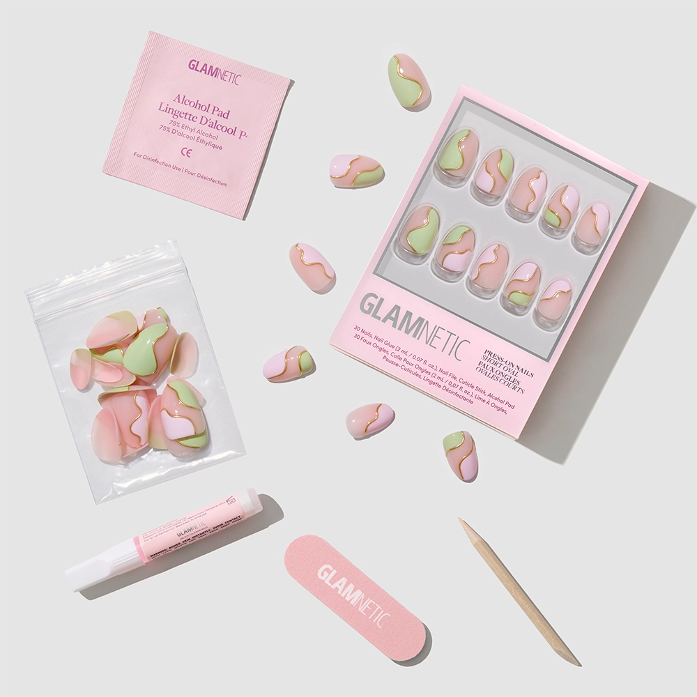 The glamnetic Strawberry Matcha Press-On Nails set features pink, green, and nude swirls with glue, alcohol pad, nail file, cuticle stick, and extra nails—all styled café-cute on a light gray background. - Product image