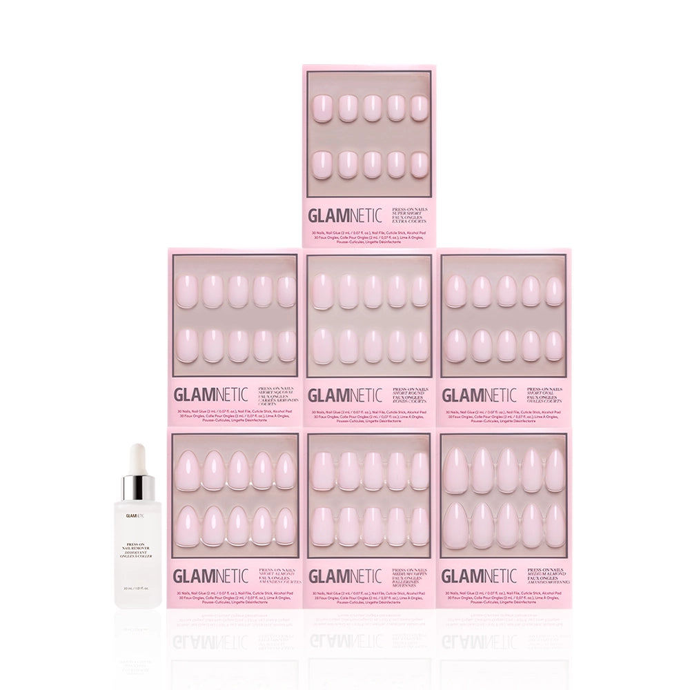Nine boxes of glamnetic’s Strawberry Milk Bundle press-on nails are stacked in a pyramid with a white nail glue bottle at the bottom left, set against a white background. - Product image