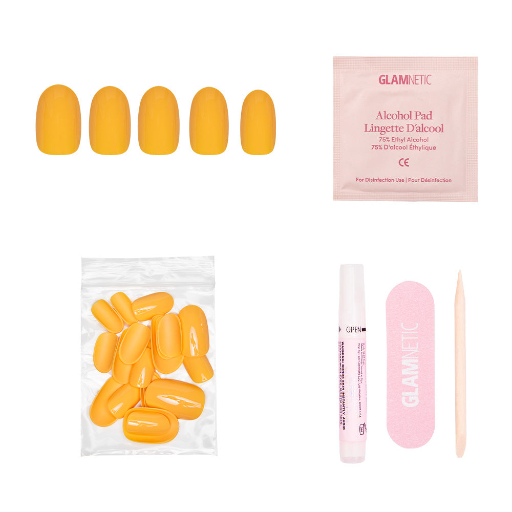 The glamnetic Sunset Orange set includes vibrant yellow press-on nails, an alcohol pad, extra nails in a bag, nail glue, a pink file, and a wooden cuticle stick—all shown on a white background. Perfect for summer style. - Product image