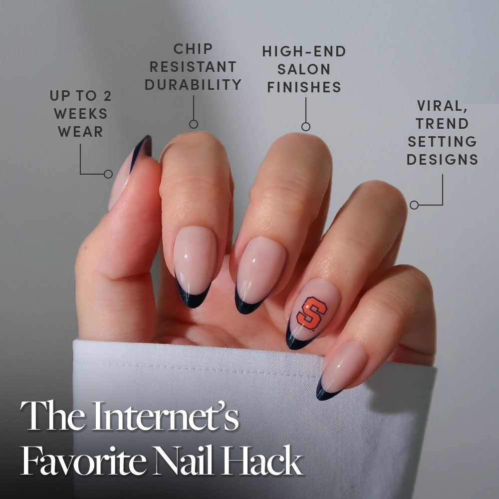 A hand with long almond-shaped nails features a black French tip and one nail with a glamnetic Syracuse Orange Press-On Nail Set decal. Enjoy up to 2 weeks of salon-quality, chip-resistant, trendsetting style from glamnetic. - Product image