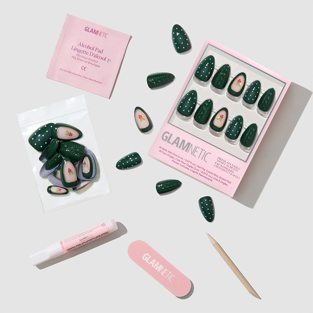 Glamnetic Table for Ten press-on nails featuring dark green short almond nails with white polka dots and cherry accents, including a storage box, extra nails, glue, a nail file, a cuticle stick, and an alcohol pad. - Product image