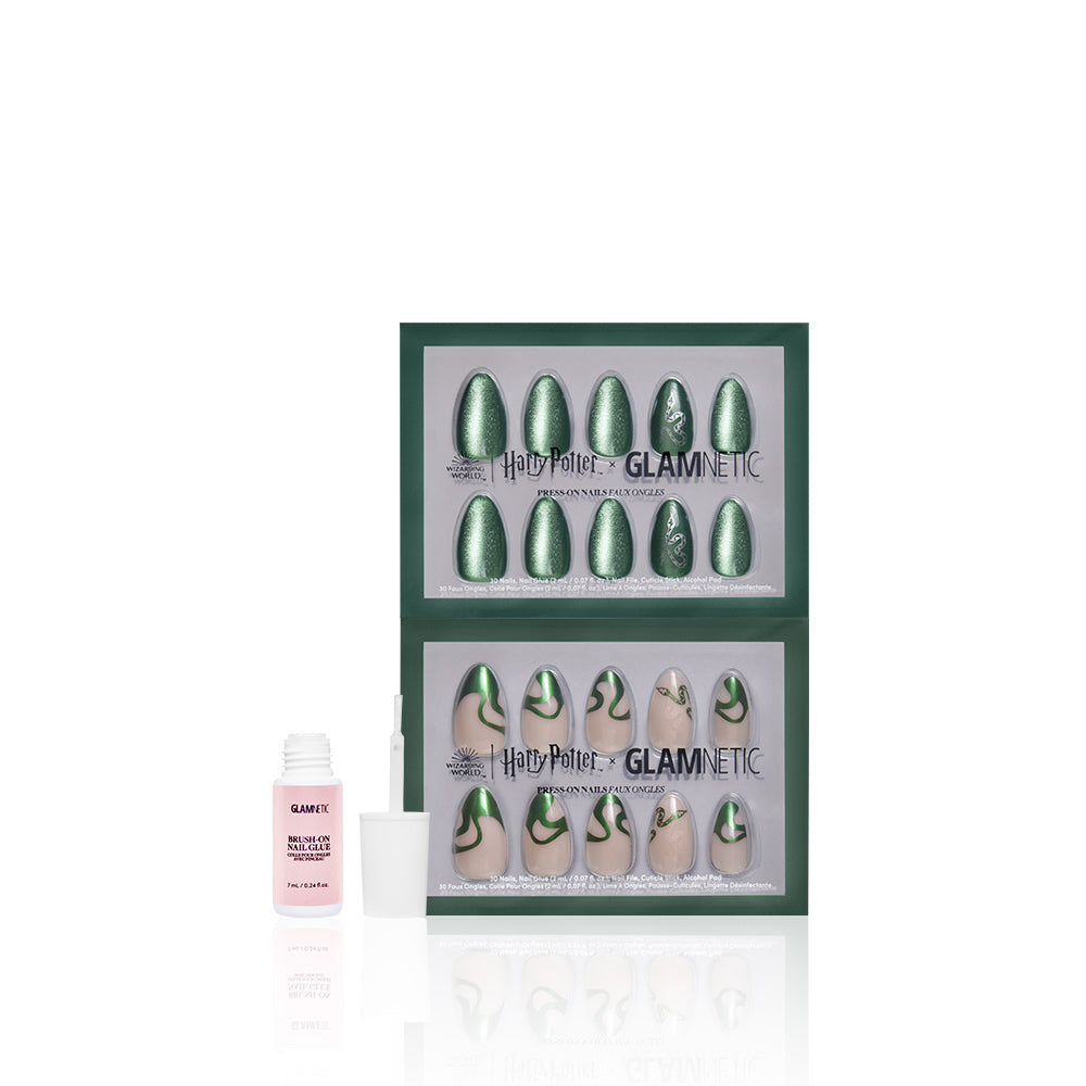 Two boxes of glamnetic Team Slytherin™ almond nails, featuring emerald green Slytherin-inspired designs, are displayed alongside a small bottle of pink, vegan and cruelty-free glamnetic nail glue on a white background. - Product image