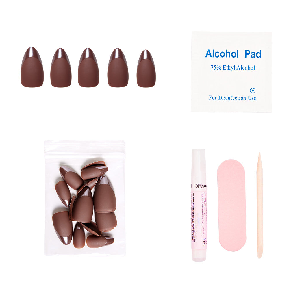 The glamnetic Terra press-on nail kit includes matte earthy-brown nails, extra nails (in a plastic bag), an alcohol pad, glue tube, pink nail file, and wooden cuticle stick—all arranged on a white background. - Product image
