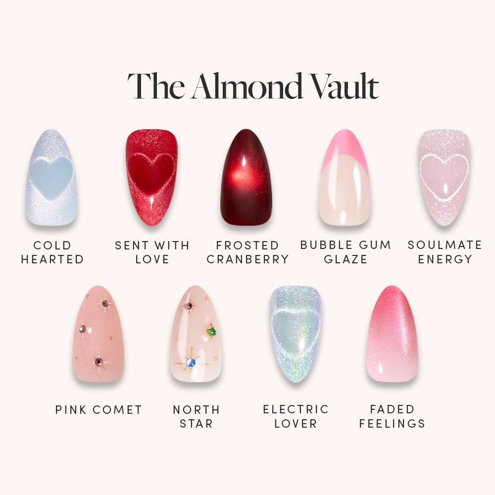 The Almond Vault by glamnetic features eight short almond press-on nails in blue glitter, red heart, red shimmer, velvet, pink with gems, blue glitter with gems, blue shimmer tip, and pink ombré designs—each labeled for easy selection.
