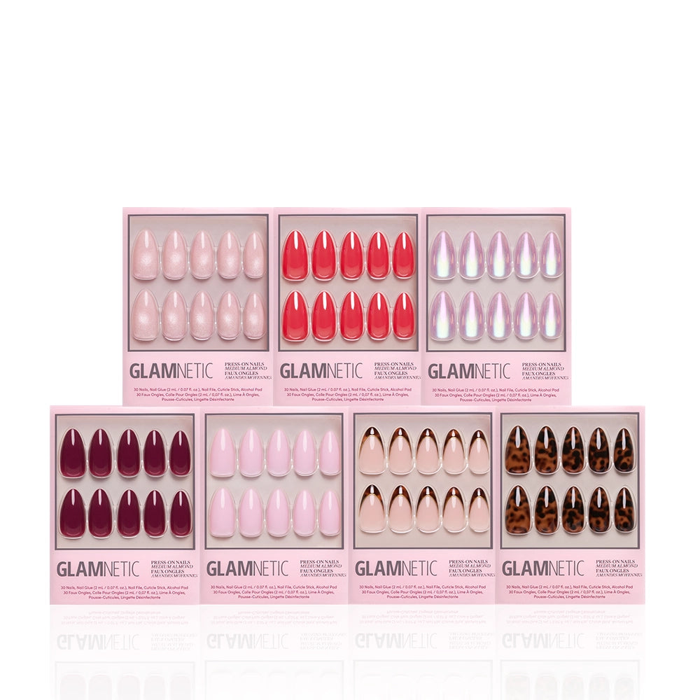 Seven boxes of glamnetic's The Medium Almond Edit press-on nails in pink, red, purple, nude, and tortoiseshell designs are arranged in two rows on a white background—ideal for a complete manicure bundle. - Product image