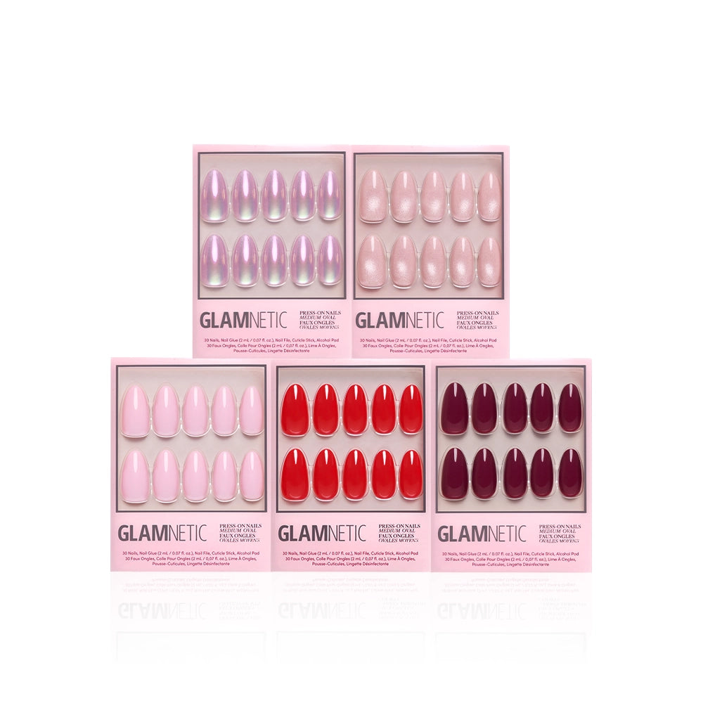 Five boxes of glamnetic's The Medium Oval Edit are arranged in two rows on a white background, showcasing medium oval press-on nails in shades from shimmery light pink to bright red and dark burgundy.