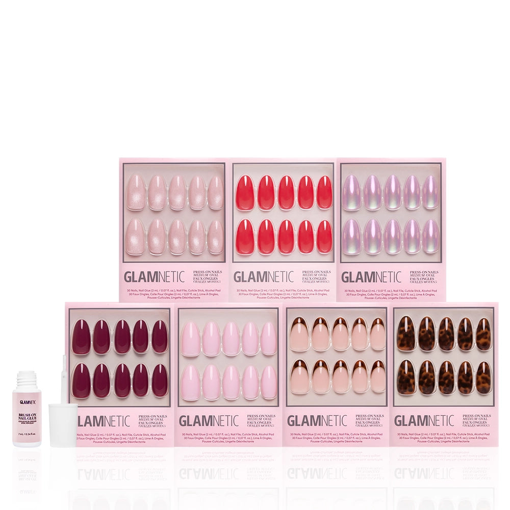 Eight boxes of Glamnetic's The Medium Oval Edit press-on nails are arranged in two rows, with a small nail glue bottle to the left, all displayed on a white background. - Product image