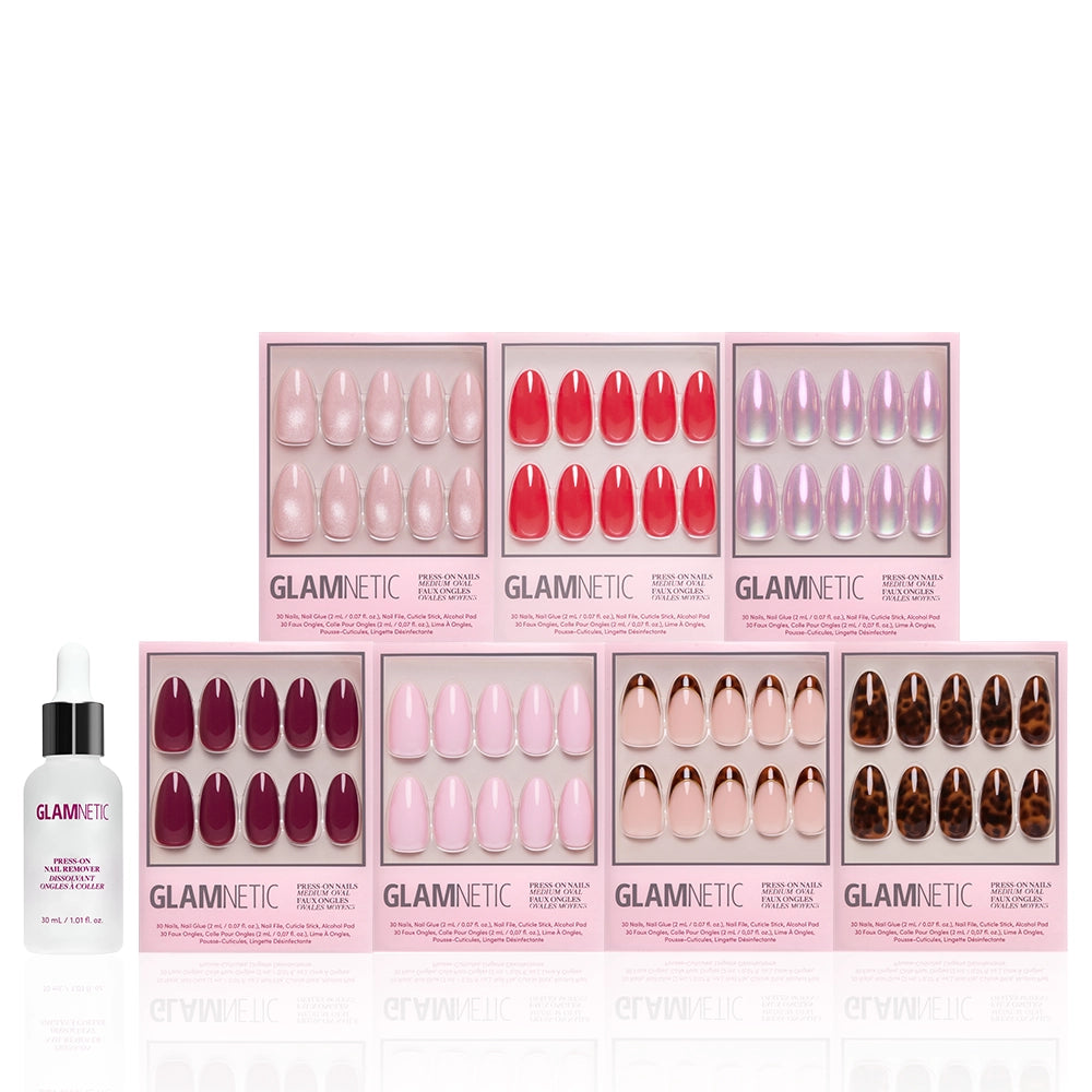 Eight boxes of glamnetic's The Medium Oval Edit press-on nails, in assorted colors and styles, are arranged in two rows, with a glamnetic press-on nail remover bottle at the front left—making an ideal mani bundle. - Product image