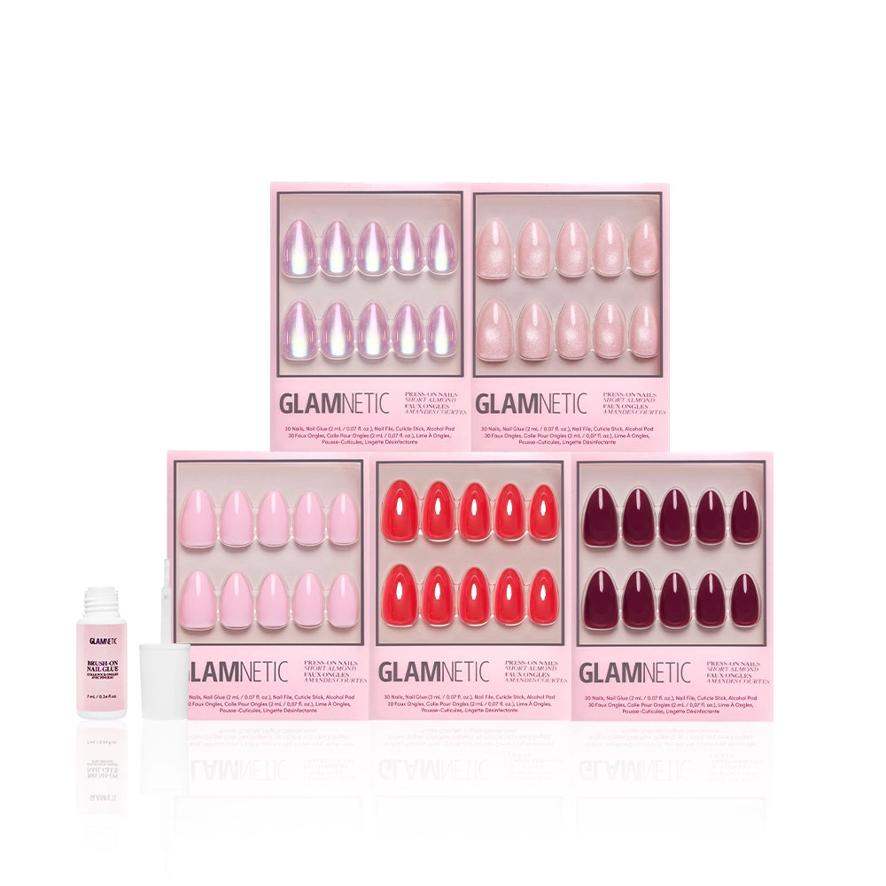 Five boxes of glamnetic's The Short Almond Edit press-on nails in pink, red, and burgundy shades are arranged in two rows with nail glue on the left, featuring chic short almond shapes against a white background. - Product image