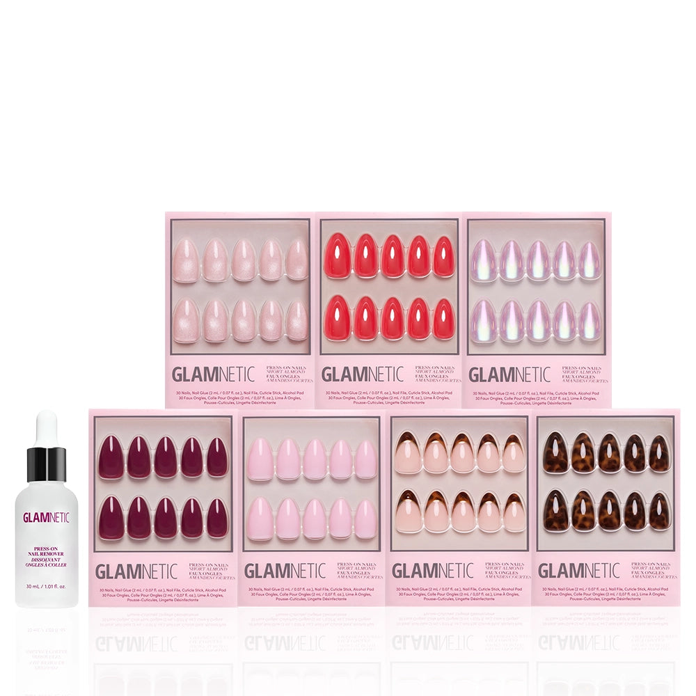 Nine boxes of Glamnetic’s The Short Almond Edit press-on nails in assorted colors and finishes are arranged in two rows, with a Glamnetic brush-on nail glue bottle placed in front on the left. - Product image
