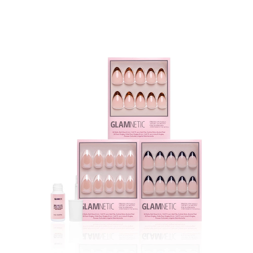 Three boxes of glamnetic's The Short Almond Frenchies, each featuring a pink French tip design, are arranged in a triangle with an open bottle of nail glue in front, all set against a white background. - Product image