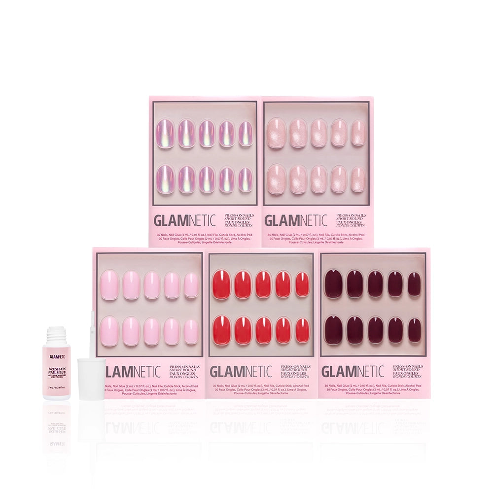 Five boxes of glamnetic's The Short Round Edit press-on nails in glossy pink, red, and purple are arranged in two rows. A nail glue bottle and nail file are next to the set on a white background. - Product image