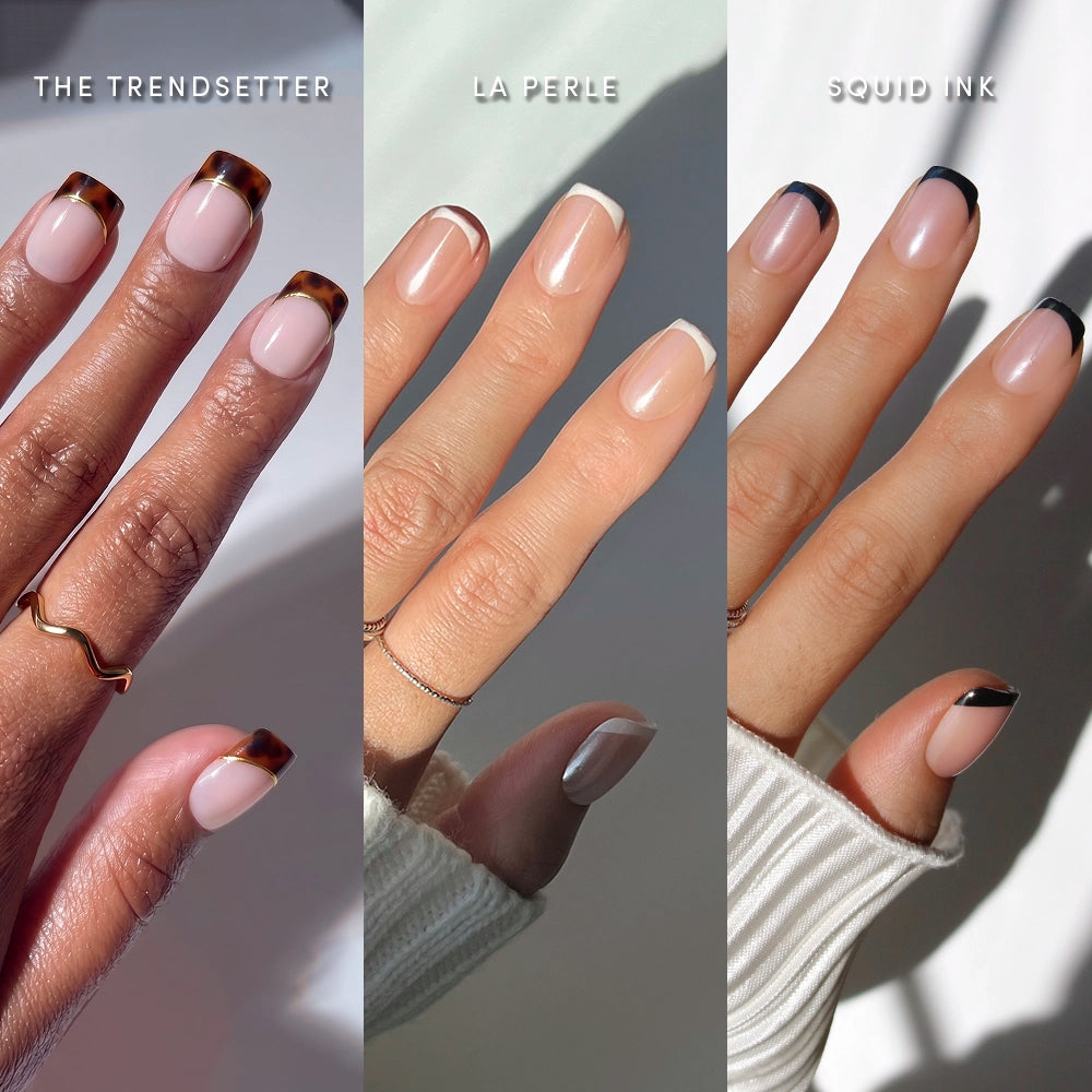 Three hands wear glamnetic’s The Short Squoval Frenchies: left features brown tortoiseshell French tips (“The Trendsetter”), center has thin white outlines (“La Perle”), right sports black French tips (“Squid Ink”)—all with neutral, glossy bases.