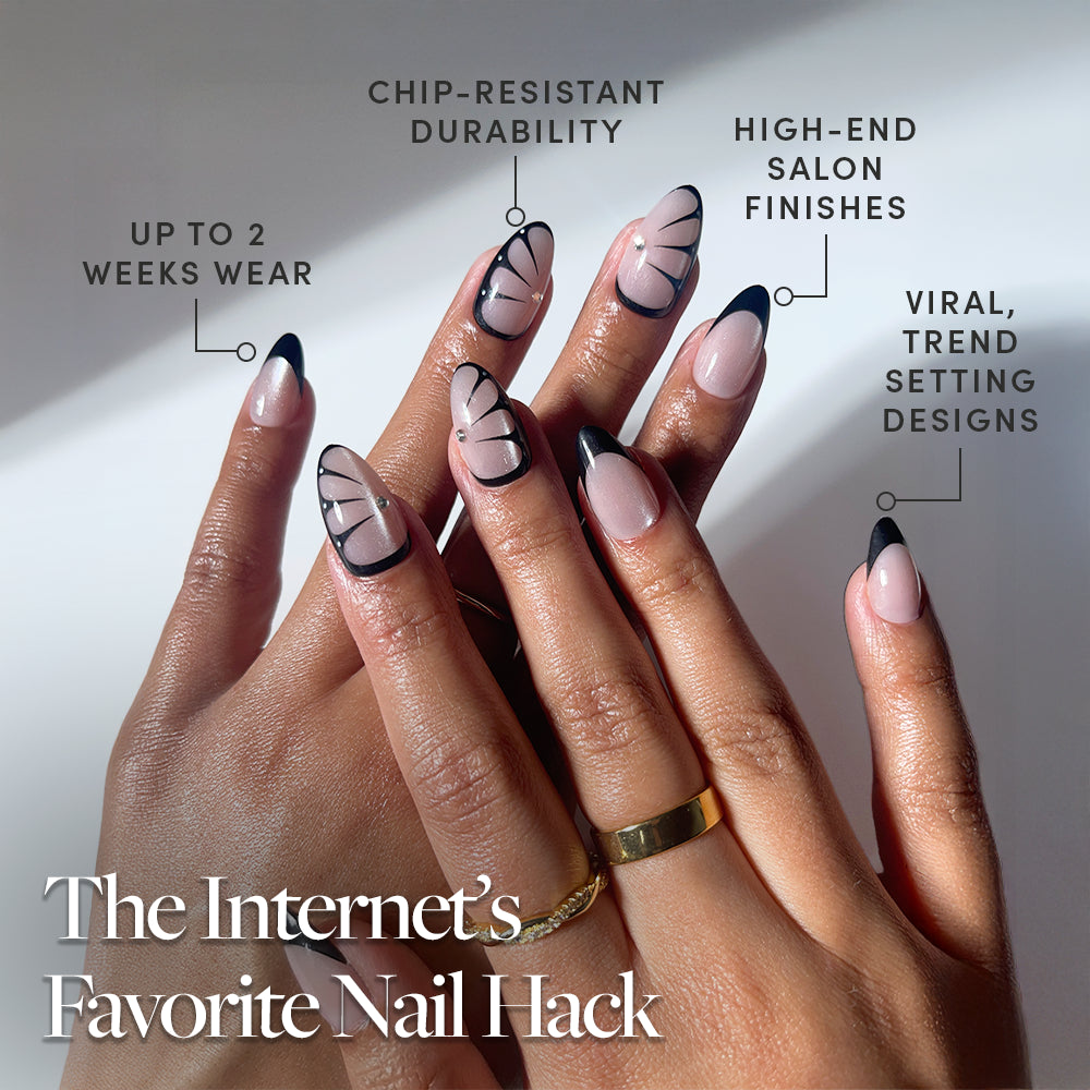 A close-up of hands wearing glamnetic’s Butterfly Effect nails—velvet nude, almond-shaped with a black French tip and abstract lines. Enjoy chip-resistant wear for up to 2 weeks, luxe finishes, and trendy designs. Text: The Internet’s Favorite Nail Hack. - Product image