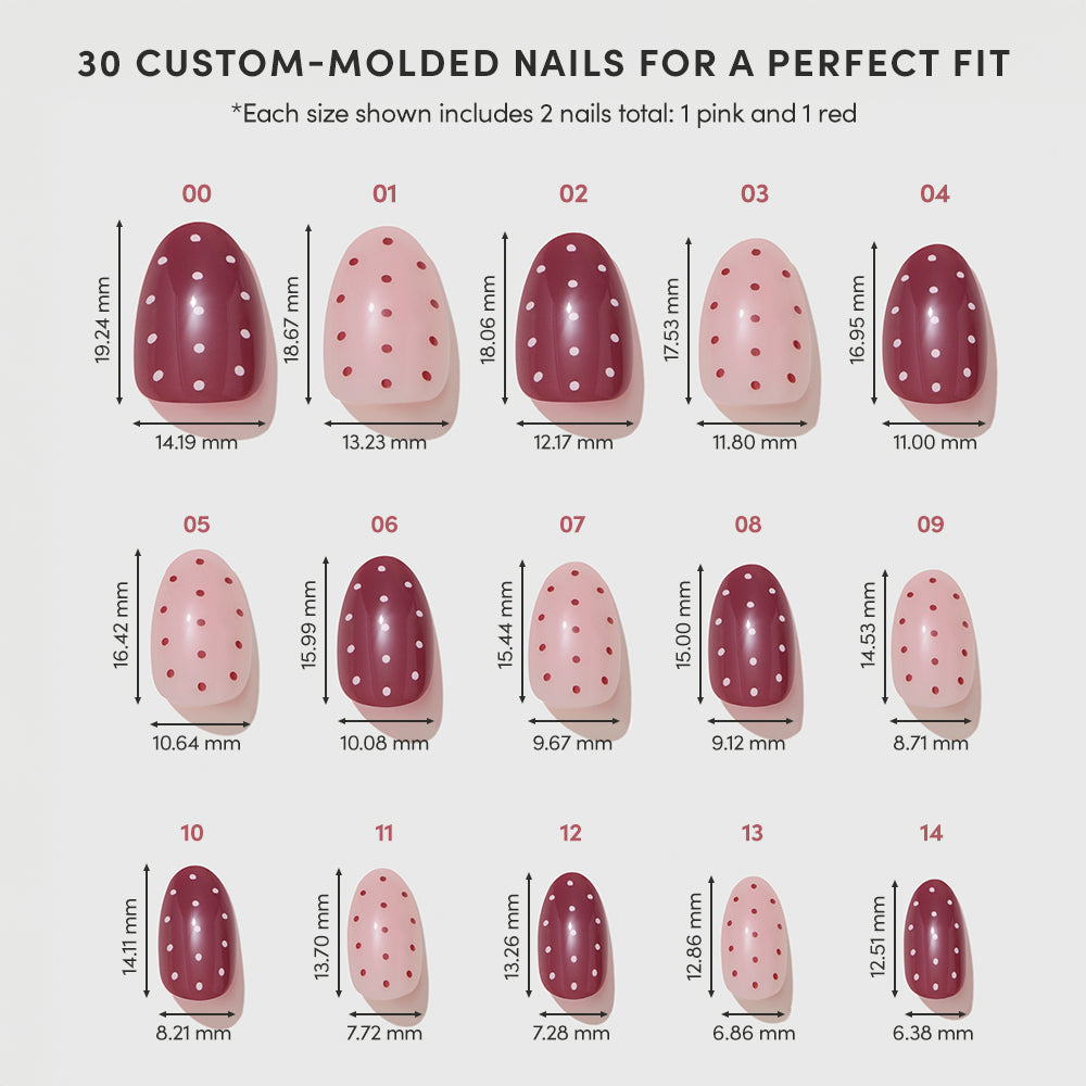 A chart displays 15 vegan, cruelty-free glamnetic Cute As Cherry Pie custom-molded red and pink polka dot nails with white spots. Millimeter length and width are listed under each of the 30 short oval press-on nails. - Product image