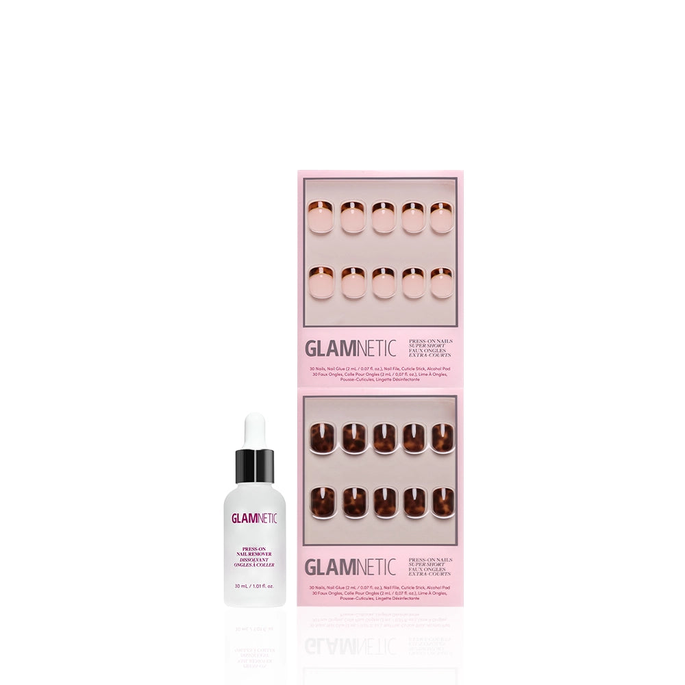 A bottle of glamnetic cuticle oil with a dropper sits beside The Super Short Tortoiseshell Duo press-ons from glamnetic, all arranged on a white background. - Product image