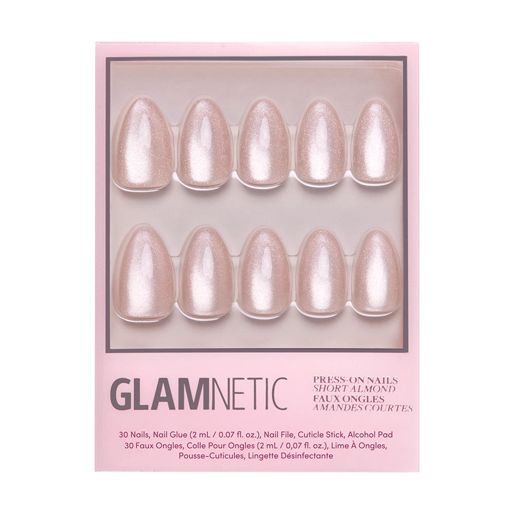 A velvet-gloss finish adds elegance to The Vow by glamnetic, a shimmery light pink short almond press-on nails set in a pink Glamnetic box. Includes 10 nails plus all application accessories. - Product image
