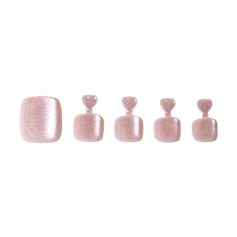 Shimmering champagne glitter press-on toenails in five sizes, each with heart-shaped tabs for application. - Product image