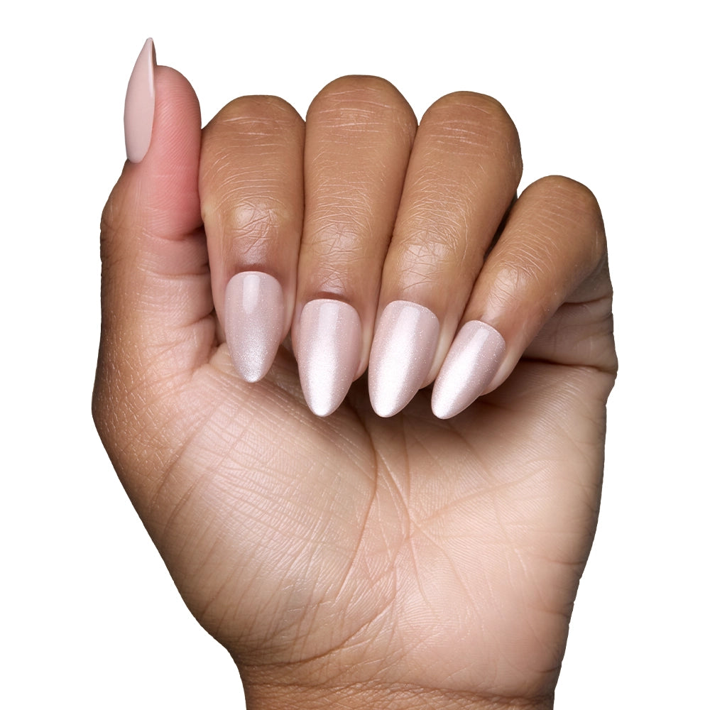 A hand with medium brown skin displays long almond nails coated in glamnetics The Vow, a shimmery pale pink nail polish with a velvet-gloss finish, set against a white background. - Product image