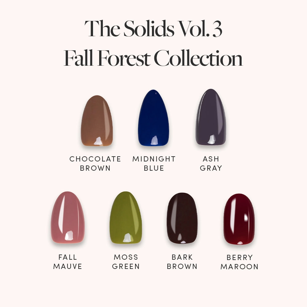 A display of seven fall shades—Chocolate Brown, Midnight Blue, Ash Gray, Fall Mauve, Moss Green, Bark Brown, and Berry Maroon—from glamnetic’s The Solids Vol.3 Fall Forest Collection short almond nail set on a light background. - Product image