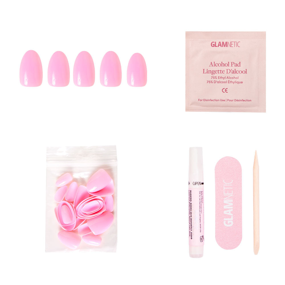 The glamnetic Think Pink set includes baby pink press-on nails, extra nails, nail glue, an alcohol pad, a matching nail file, and a wooden cuticle stick—all arranged on a white background. - Product image