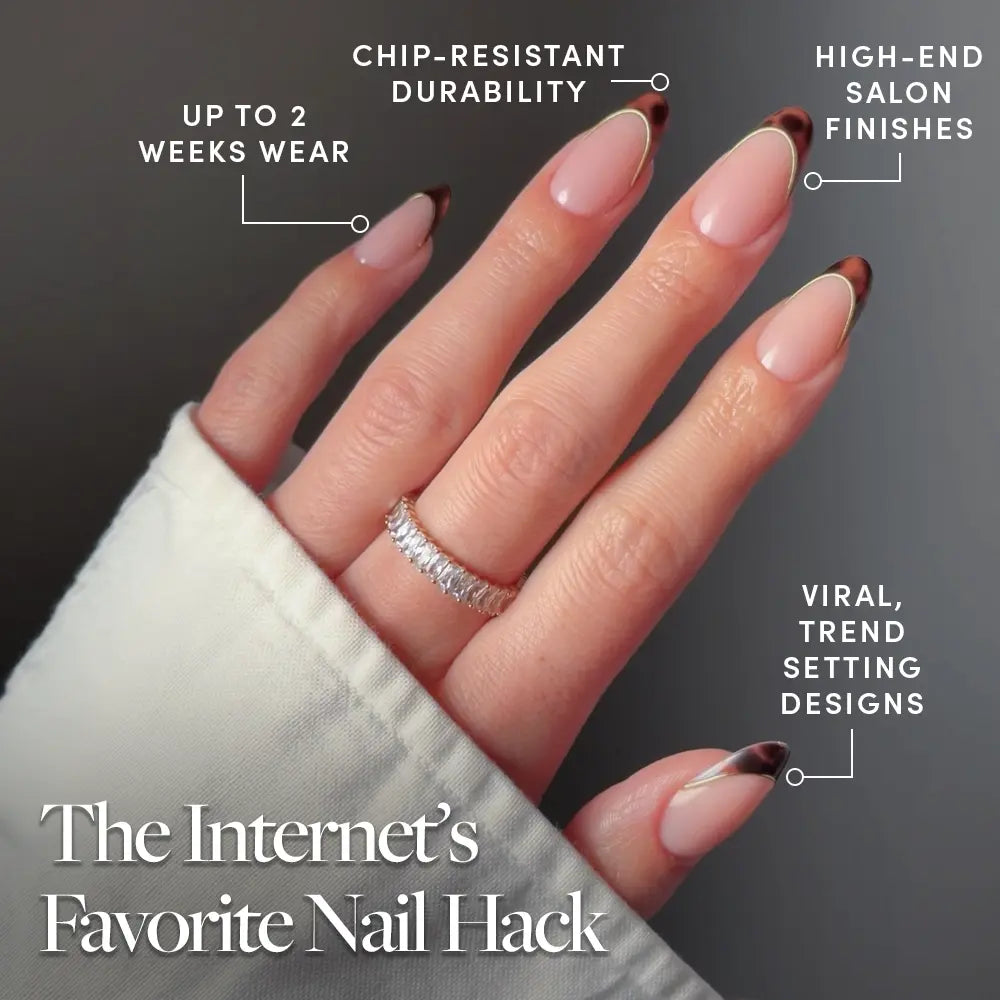 A hand wears glamnetic’s "Too Much" long, almond-shaped press-on nails with brown tortoiseshell French tips. A sparkling ring accents one finger. Enjoy up to 2 weeks' wear, chip-resistant durability, salon-quality finish, and trend-setting design. - Product image