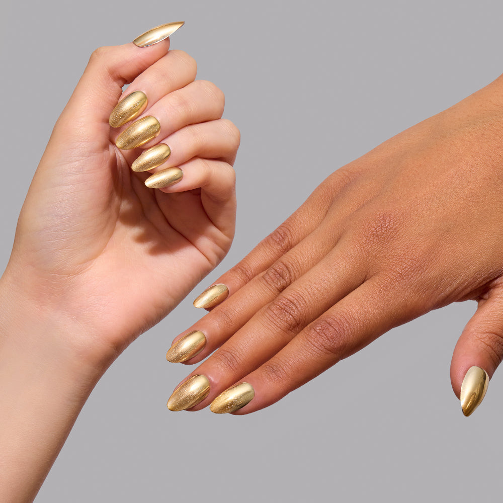 Two hands featuring short almond-shaped gold chrome Trophy Wives press-on nails. - Product image
