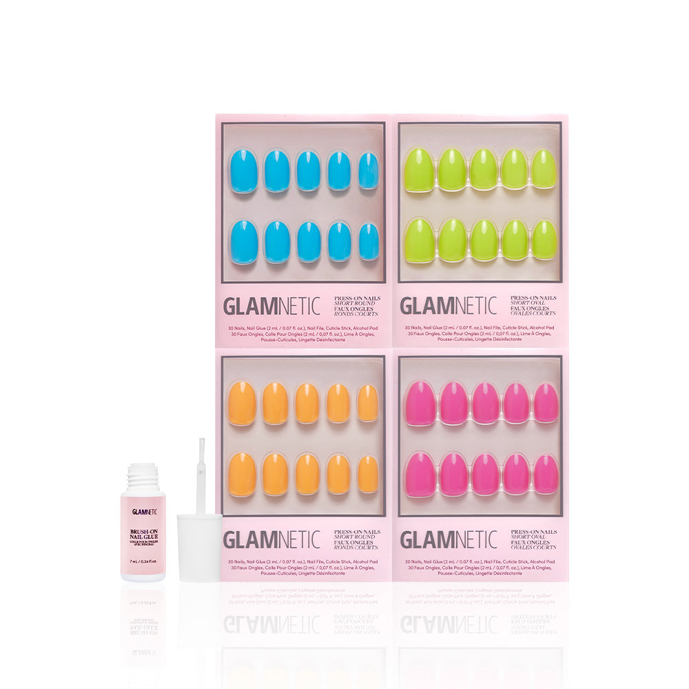 Four boxes of glamnetic Tropic Like Its Hot press-on nails in vibrant blue, green, orange, and pink form a square with an open nail glue bottle in front—perfect for summer vibes against a white background. - Product image