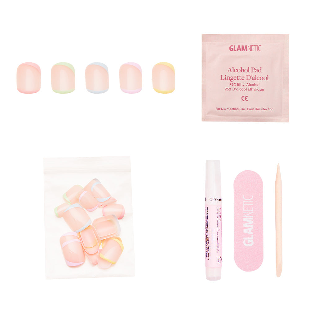 The glamnetic Tutti Frutti press-on nail kit includes super short pastel nails, adhesive, alcohol pad, nail file, wooden cuticle stick, and extra vegan & cruelty-free nails in a clear bag, all displayed on a white background. - Product image