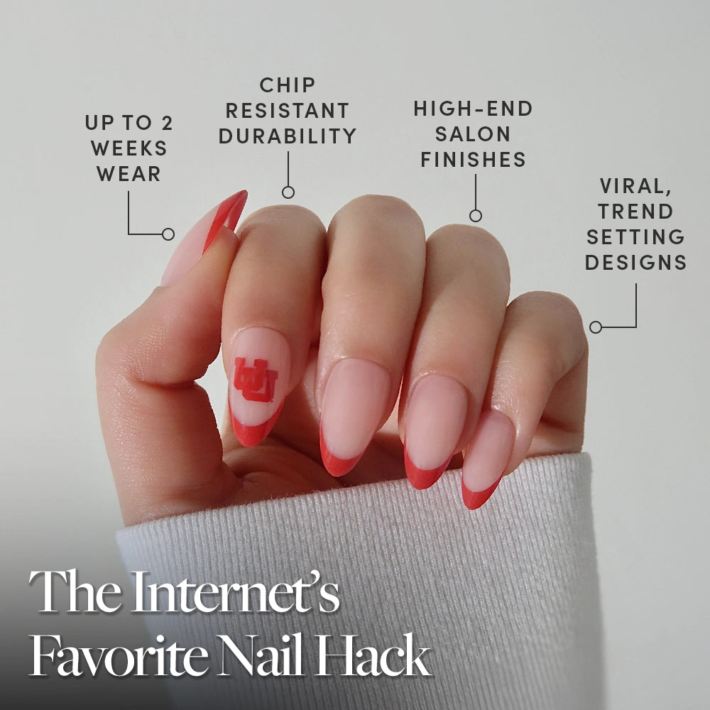 A hand with almond-shaped Utah Utes Press-On Nails by glamnetic, featuring bold red French tips and a standout red ring finger. Enjoy long wear, chip resistance, salon-quality nails, and trendy designs. The Internet’s Favorite Nail Hack. - Product image
