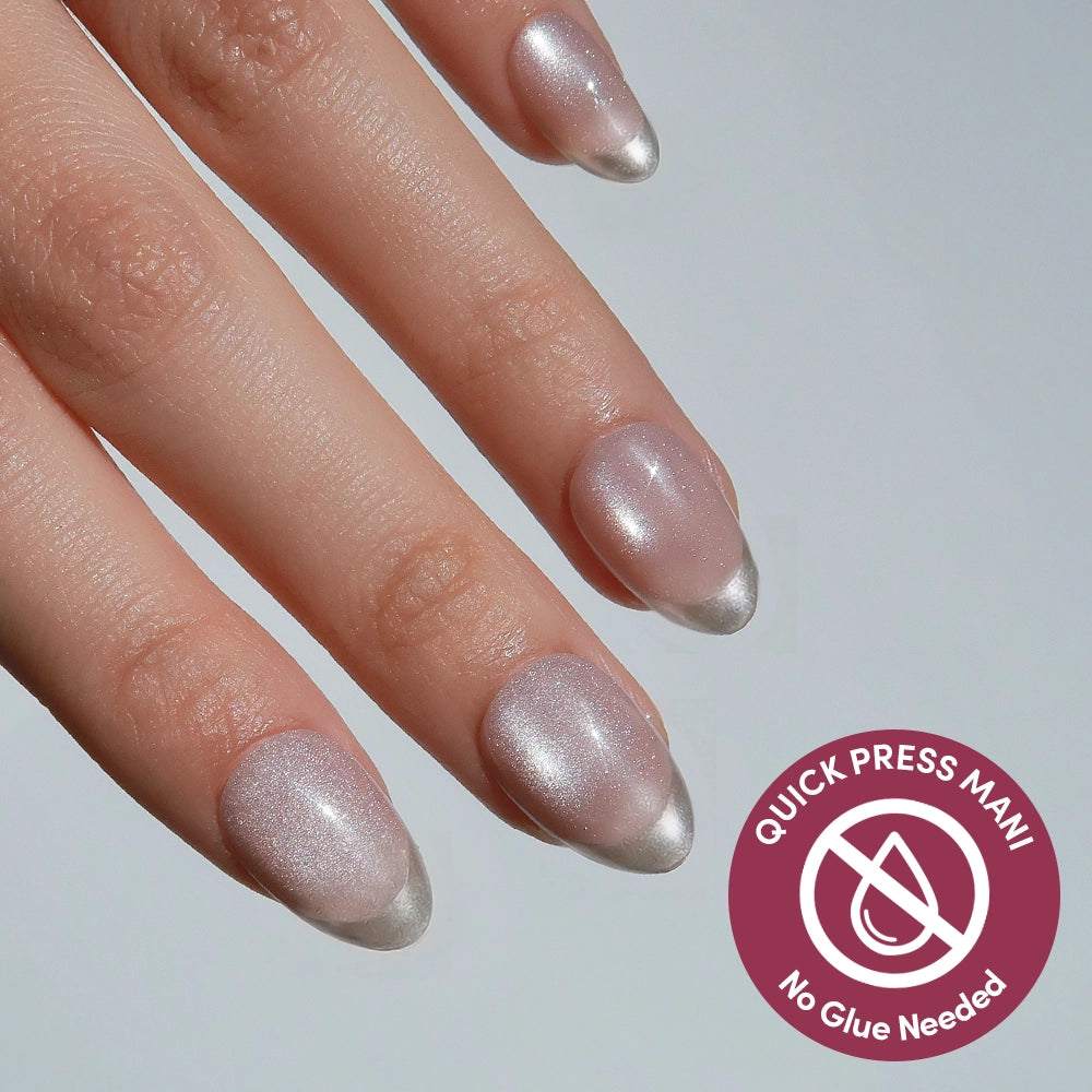 A close-up of a hand with almond-shaped, pearly pink glamnetic Velvet Chrome Press On Nails with silver tips. A circular label reads QUICK PRESS MANI No Glue Needed—perfect stick-ons for effortless style. - Product image