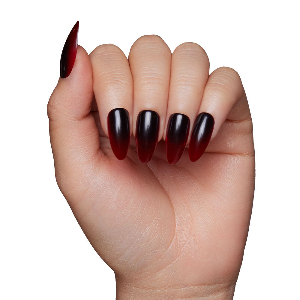 A hand with long, almond-shaped nails featuring glamnetic’s Vampiress—a glossy black-to-blood ombre manicure—perfect for Halloween nails, displayed against a white background. - Product image