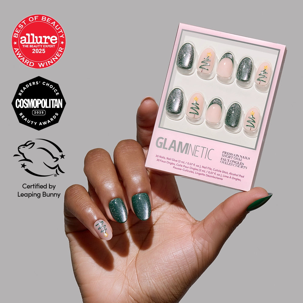 A hand adorned with green and accent Christmas tree nail art holds the glamnetic Velvet Pine velvet press-on nails kit. Award badges from Allure, Cosmopolitan, and Leaping Bunny are displayed on the left—making this chic short oval set perfect for finishing your festive holiday manicure.