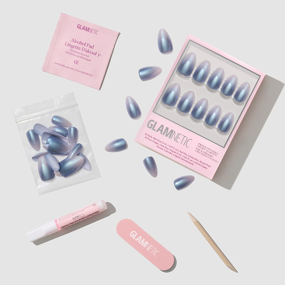 A set of Vintage Silver press-on nails, a glazed nail set, an alcohol pad, nail glue, a nail file, a cuticle stick, and extra nails are arranged on a light background. All items are branded glamnetic. - Product image