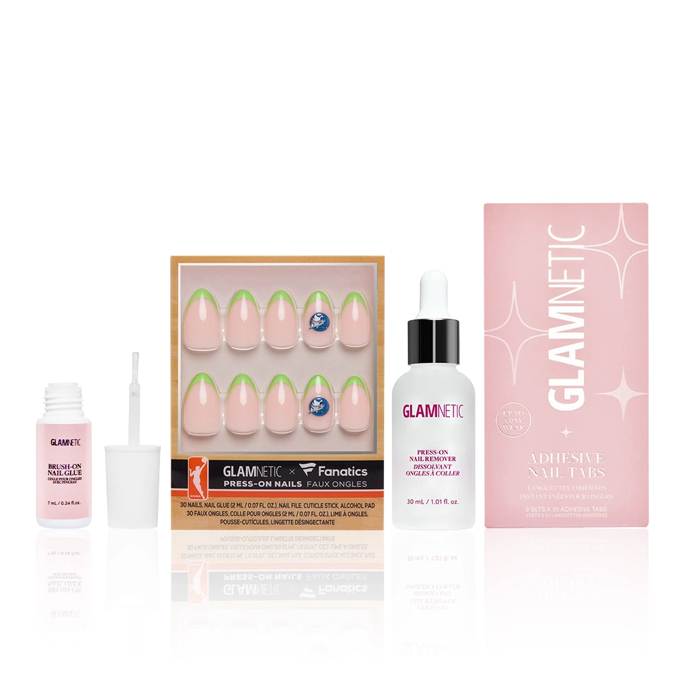 The Minnesota Lynx Lineup by glamnetic: a set of press-on nails with a pink and green design, fan nail art, nail glue, adhesive bottle, and Glamnetic Adhesive Nail Tabs in a pink box, all arranged on a white background.